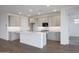 Bright kitchen featuring gray cabinets, granite countertops, and a large island with breakfast bar at 17322 W Via Dona Rd, Surprise, AZ 85387