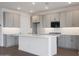 Bright kitchen featuring gray cabinets, granite countertops, and a large island with breakfast bar at 17322 W Via Dona Rd, Surprise, AZ 85387