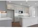 Bright kitchen features modern appliances, white cabinets, and center island with sink at 17322 W Via Dona Rd, Surprise, AZ 85387