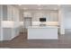 Bright kitchen featuring gray cabinets, granite countertops, and a large island with breakfast bar at 17322 W Via Dona Rd, Surprise, AZ 85387