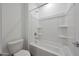 Bathroom showcasing a bathtub and shower combination with white tile surround and modern fixtures and a toilet at 17445 W Via Dona Rd, Surprise, AZ 85387
