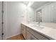 Bathroom featuring double sinks with modern fixtures, bright countertops, and a large mirror for a luxurious feel at 17445 W Via Dona Rd, Surprise, AZ 85387