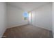 Carpeted bedroom with a window and a door to enter the home at 17445 W Via Dona Rd, Surprise, AZ 85387