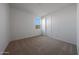 Carpeted bedroom with a window and a door to enter the home at 17445 W Via Dona Rd, Surprise, AZ 85387