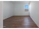Neutral bedroom with hardwood floors and a view of the block fence outside the window at 17445 W Via Dona Rd, Surprise, AZ 85387