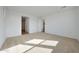 Spacious bedroom featuring plush carpet, ample natural light, and ensuite bathroom at 17445 W Via Dona Rd, Surprise, AZ 85387