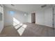 Carpeted bedroom with bright natural light and a view to the ensuite bathroom at 17445 W Via Dona Rd, Surprise, AZ 85387