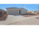 Attractive one-story home with two-car garage, desert landscape, and covered entry way at 17445 W Via Dona Rd, Surprise, AZ 85387