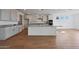 Beautiful kitchen with a large island featuring granite countertops, white cabinets, and stainless steel appliances at 17445 W Via Dona Rd, Surprise, AZ 85387