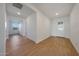 Bright living room showcasing sleek hardwood floors and a sunlit entry door at 17445 W Via Dona Rd, Surprise, AZ 85387
