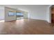 Bright living room features wood-look tile flooring, recessed lighting, and large windows providing ample natural light at 17445 W Via Dona Rd, Surprise, AZ 85387
