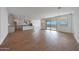 Open-concept living space featuring sleek flooring, natural light, open kitchen and backyard access perfect for entertaining at 17445 W Via Dona Rd, Surprise, AZ 85387