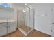 Bathroom with a glass shower, tile surround, and honey comb floor at 17445 W Via Dona Rd, Surprise, AZ 85387