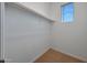 Bright walk-in closet with carpet, a window providing natural light, and a built-in rod for ample storage at 17445 W Via Dona Rd, Surprise, AZ 85387