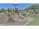 Community playground featuring slides, climbing structures, shade, and comfortable seating at 17619 W Oberlin Way, Surprise, AZ 85387