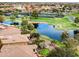 Expansive aerial view showcases the community, pond, landscaping, putting green, and surrounding neighborhood at 20623 N Enchantment Pass, Maricopa, AZ 85138