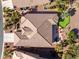 Aerial view of the house showcases a backyard putting green, fire pit area, patio, desert landscaping, and roof at 20623 N Enchantment Pass, Maricopa, AZ 85138