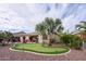 Backyard putting green and palm tree, patio, fire pit, and comfortable outdoor seating at 20623 N Enchantment Pass, Maricopa, AZ 85138