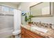 Bathroom with tiled shower/tub, granite vanity, and mosaic backsplash at 20623 N Enchantment Pass, Maricopa, AZ 85138