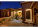 Inviting outdoor patio space with comfortable seating, an intricate entry door, and exterior lighting at 20623 N Enchantment Pass, Maricopa, AZ 85138