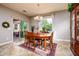 Cozy dining room with natural wood table, chandelier, and sliding door access to patio at 20623 N Enchantment Pass, Maricopa, AZ 85138