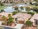Stunning single-story home with well-manicured landscaping, a large lake view, and a private driveway at 20623 N Enchantment Pass, Maricopa, AZ 85138