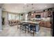 Spacious kitchen with island, seating, granite countertops, and seamlessly adjoining dining area at 20623 N Enchantment Pass, Maricopa, AZ 85138