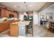 Open concept kitchen featuring a granite island with bar seating, and views into living room at 20623 N Enchantment Pass, Maricopa, AZ 85138