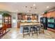Open kitchen with island seating, pendant lighting, cabinetry, and adjacent dining area at 20623 N Enchantment Pass, Maricopa, AZ 85138