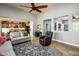 Open-concept living room showcasing tile floors, comfortable seating, and a view into a modern kitchen with stainless steel appliances at 20623 N Enchantment Pass, Maricopa, AZ 85138