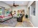 Open-concept living room with tile floors, neutral furnishings, and seamless flow into the kitchen at 20623 N Enchantment Pass, Maricopa, AZ 85138