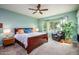 Serene bedroom with lake views, a dark wood bed frame, and a comfortable chair at 20623 N Enchantment Pass, Maricopa, AZ 85138