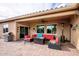 Covered patio with comfortable seating, stainless steel grill, and an outdoor living space at 20623 N Enchantment Pass, Maricopa, AZ 85138