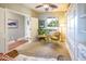 Comfortable sitting room with a built-in Murphy bed, wicker seating, and ample natural light perfect for relaxation and productivity at 20623 N Enchantment Pass, Maricopa, AZ 85138