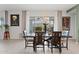 Dining area features a dark wood table, seating for six, and sliding glass doors at 2113 W Samantha Way, Phoenix, AZ 85041