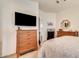 Bright bedroom with a wall-mounted TV and coordinated wooden furniture at 2206 S Ellsworth Rd # 149B, Mesa, AZ 85209