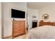 Bright bedroom with a wall-mounted TV and coordinated wooden furniture at 2206 S Ellsworth Rd # 149B, Mesa, AZ 85209