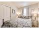 Cozy bedroom featuring a comfortable bed with patterned bedding, and a mirrored closet door at 2206 S Ellsworth Rd # 149B, Mesa, AZ 85209