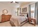 Well-lit bedroom offering a bed, dresser, and elegant decor for a relaxing atmosphere at 2206 S Ellsworth Rd # 149B, Mesa, AZ 85209