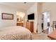 Cozy bedroom featuring an ensuite bathroom, natural light, and comfortable carpet at 2206 S Ellsworth Rd # 149B, Mesa, AZ 85209