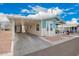 Single story home with a carport, side entrance, and covered porch with seating at 2206 S Ellsworth Rd # 149B, Mesa, AZ 85209