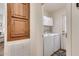 Well-organized laundry room with overhead cabinets and modern white washer and dryer at 2206 S Ellsworth Rd # 149B, Mesa, AZ 85209