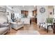 The open living room and kitchen with hardwood floors provide seamless flow and functionality at 2206 S Ellsworth Rd # 149B, Mesa, AZ 85209