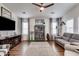 Spacious living room with hardwood floors, tv, and a large bookcase at 2206 S Ellsworth Rd # 149B, Mesa, AZ 85209