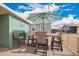 Outdoor dining area with patio table and chairs, shaded by a large umbrella at 2206 S Ellsworth Rd # 149B, Mesa, AZ 85209