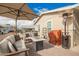 Relaxing patio with comfortable seating, a fire table, and overhead umbrella at 2206 S Ellsworth Rd # 149B, Mesa, AZ 85209