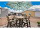 Inviting outdoor patio features a dining table set shaded by a colorful umbrella at 2206 S Ellsworth Rd # 149B, Mesa, AZ 85209