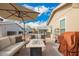 Relaxing patio area with comfortable seating, a modern fire pit table, and barbecue grill at 2206 S Ellsworth Rd # 149B, Mesa, AZ 85209