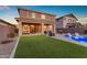 Inviting backyard with a covered patio, artificial grass, and a pool, great for outdoor entertaining at 25582 S 224Th Way, Queen Creek, AZ 85142