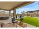 Inviting backyard with covered patio, outdoor seating, pool, artificial grass, and well-manicured landscaping at 25582 S 224Th Way, Queen Creek, AZ 85142